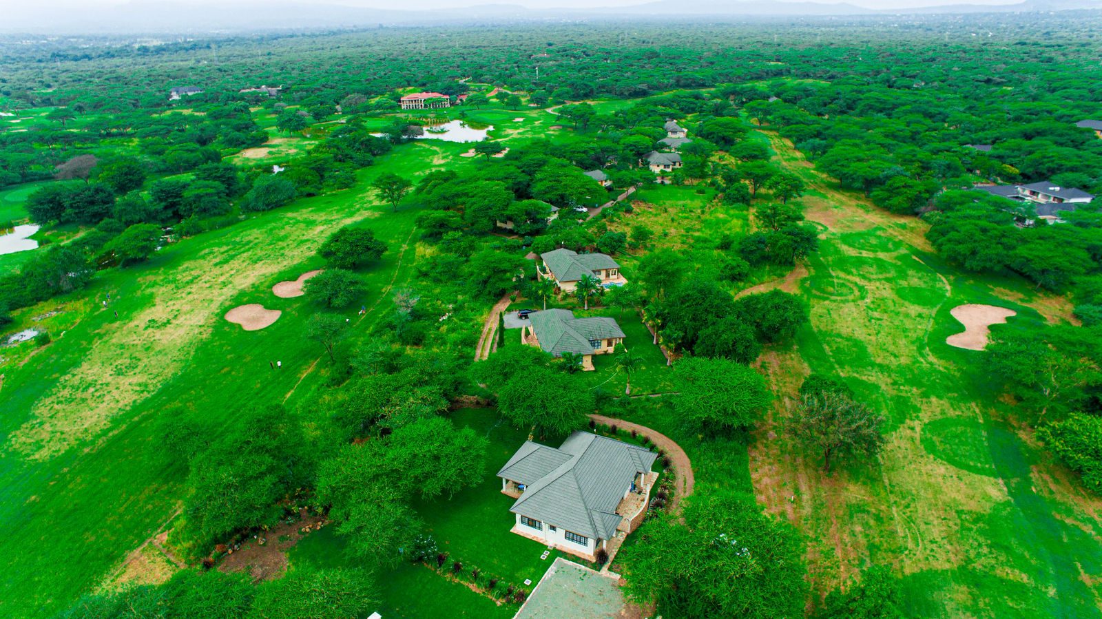 Aerial view of Kili Golf Estate with the cottage among the trees and fairways