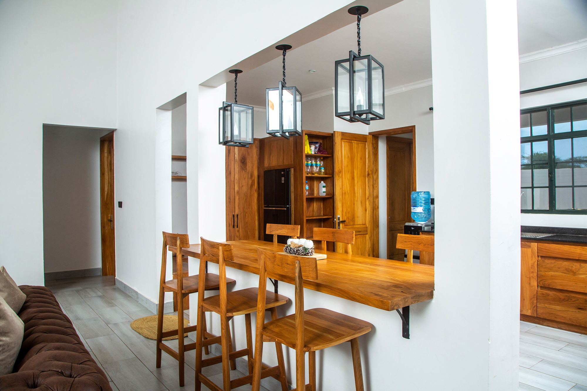 Dining table and kitchen bar under pendant lights