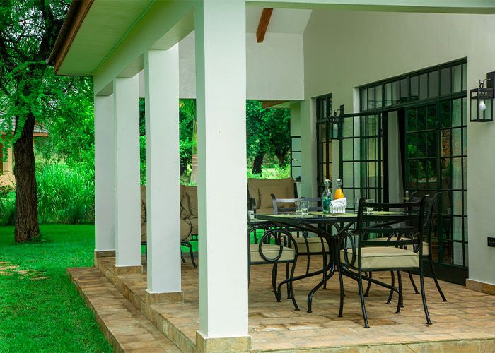 Veranda columns and outdoor table looking over the garden